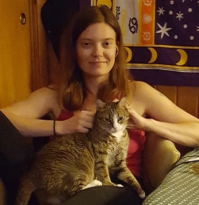 hilary-sitting-with-cat-lola Woman in pink shirt sitting with a cat on her lap