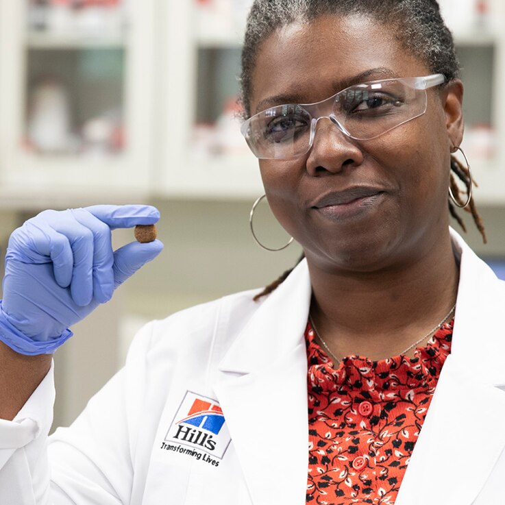 research scientist holding kibble